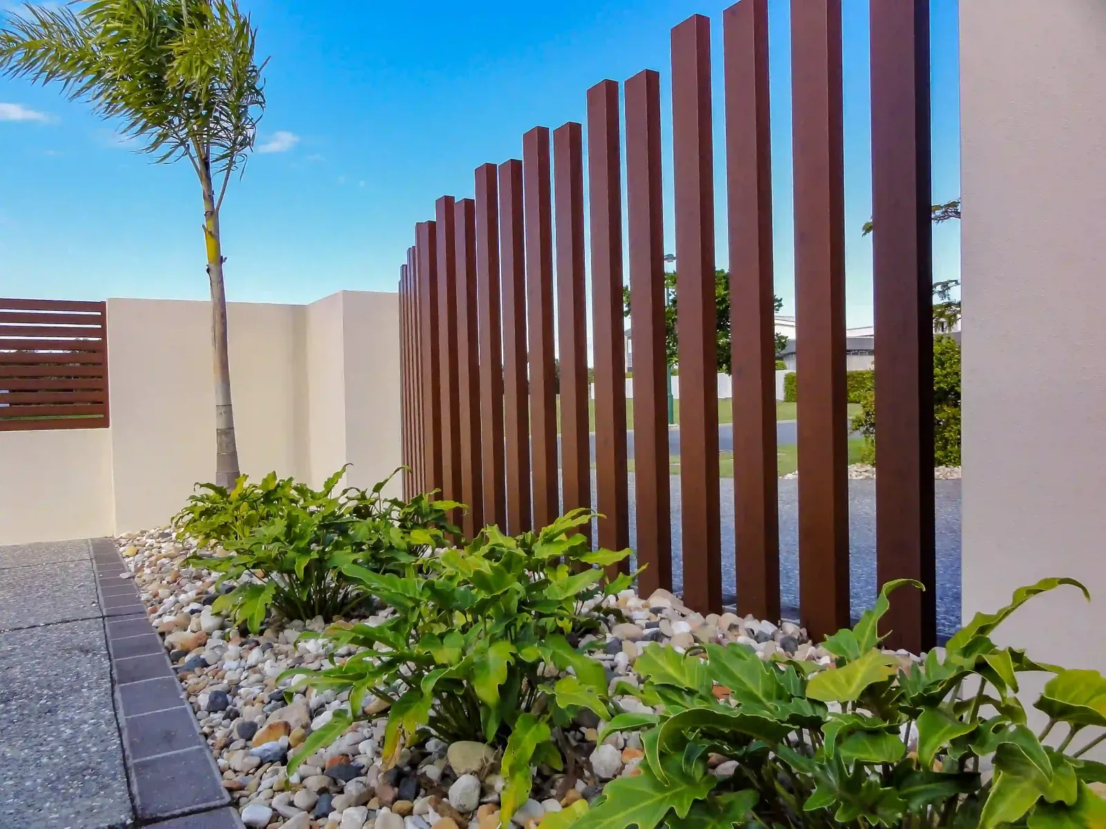 Angled timber batten fence with spaced vertical battens