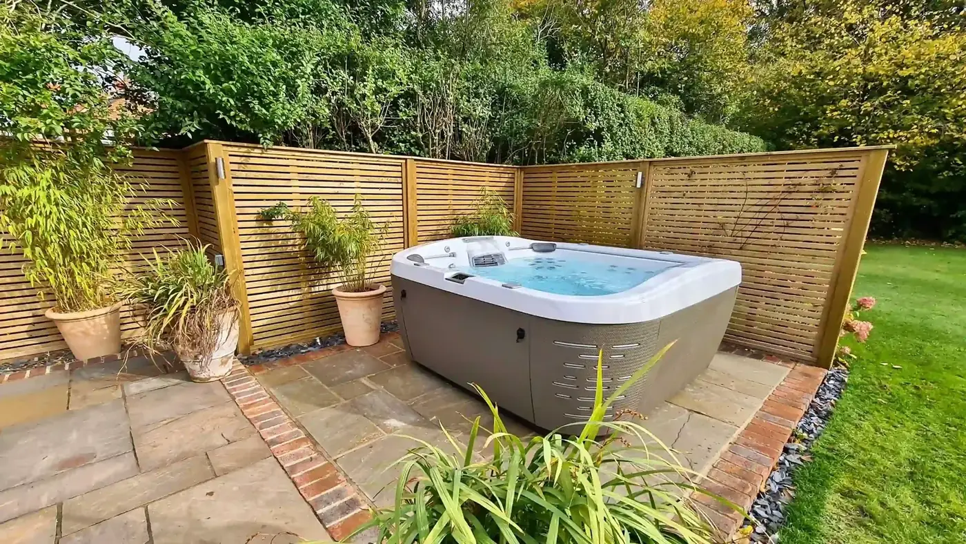 Timber slat privacy screen surrounding a backyard spa pool