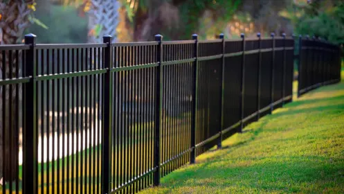 Black aluminium fence installed in a garden setting