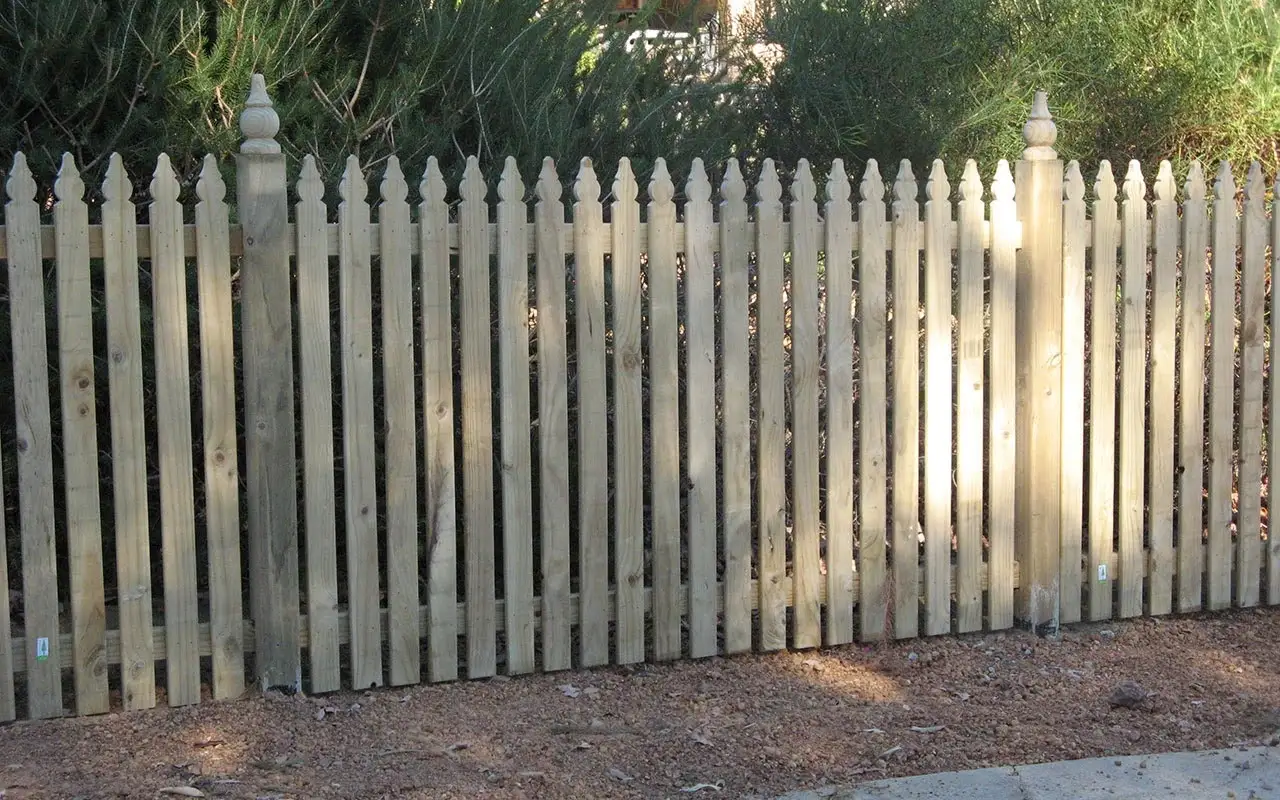 Timber colonial picket fence with decorative finial post caps