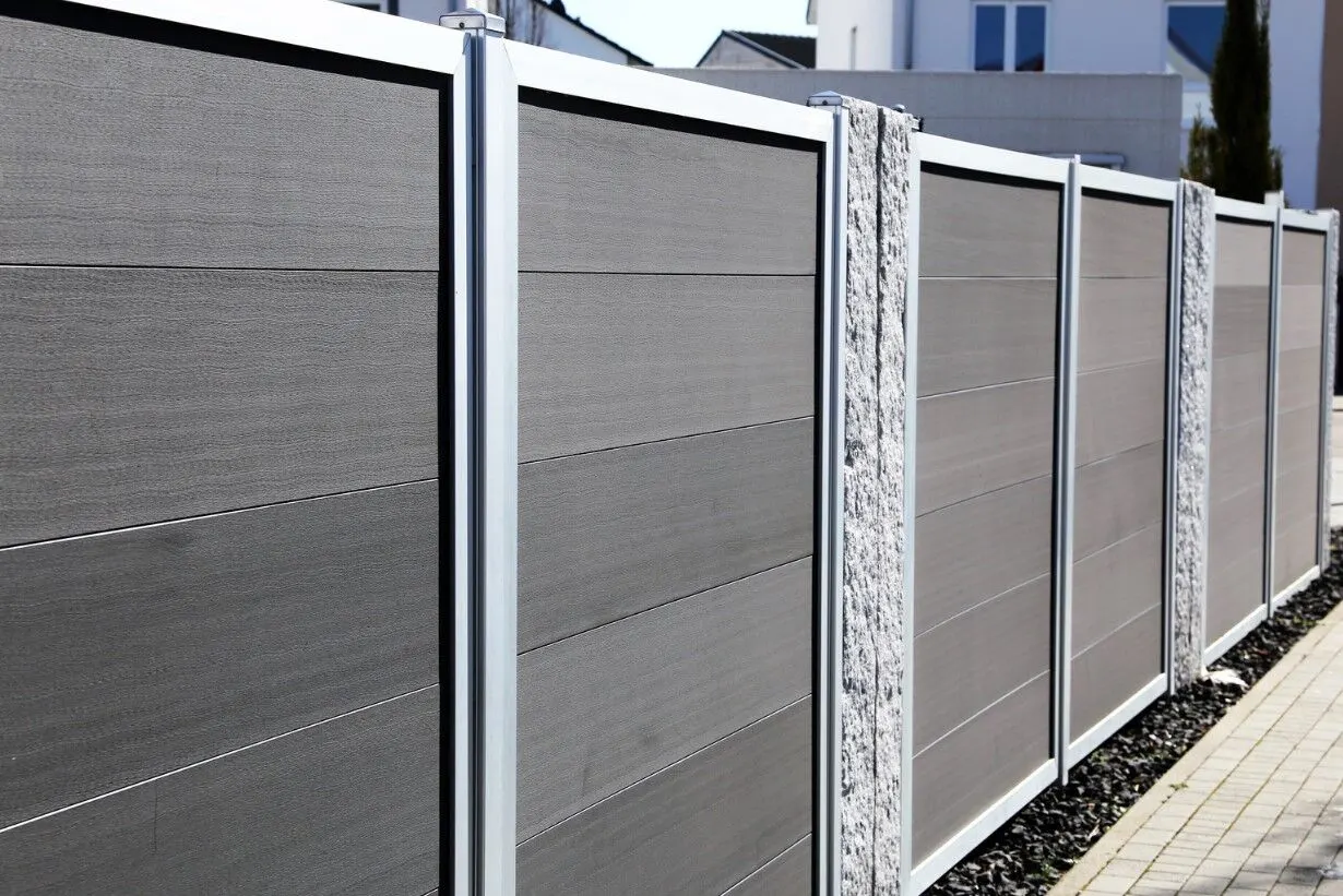 Modern grey composite fence panels with aluminium posts in front of a home