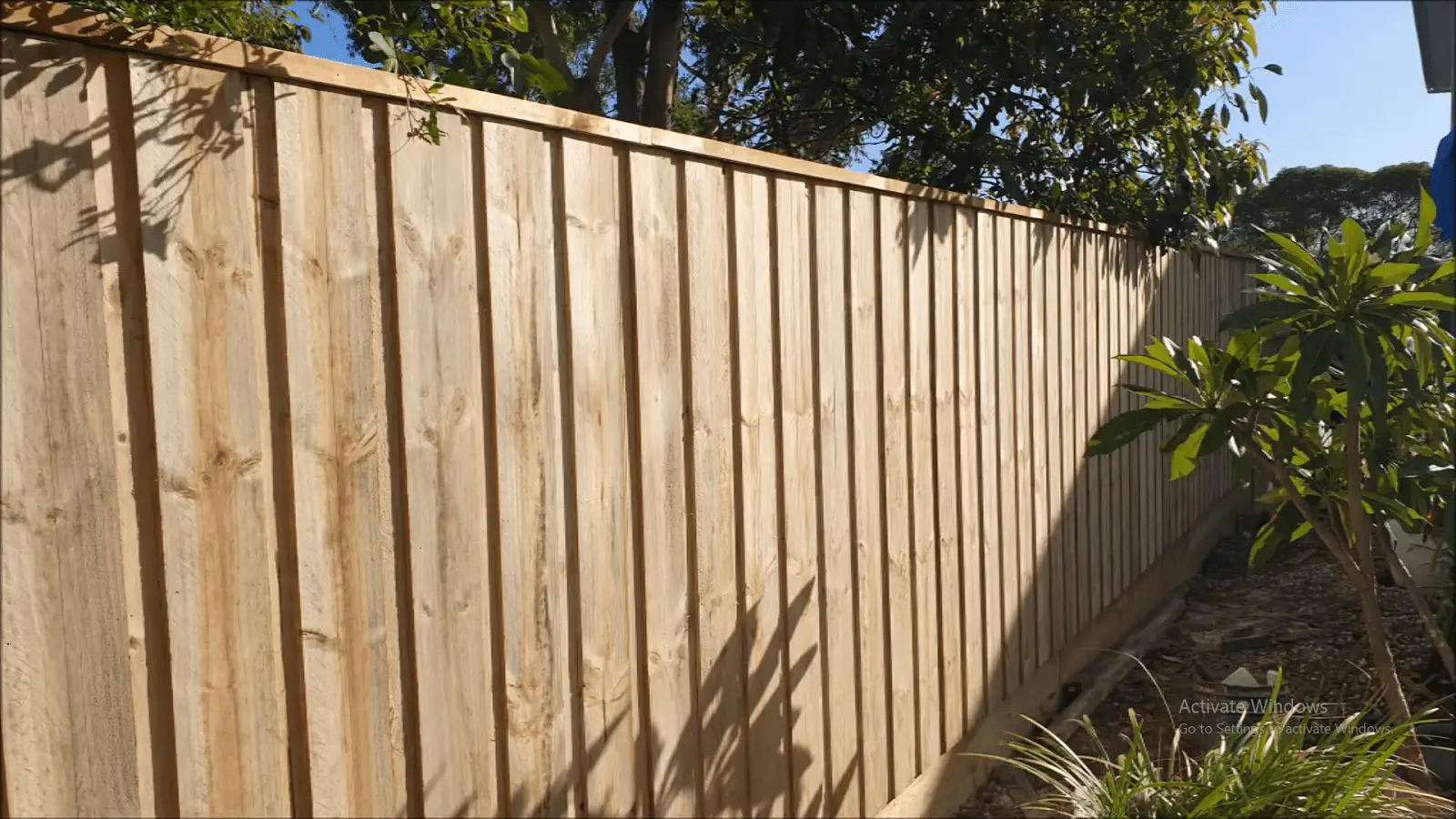 Lapped timber fence creating a solid privacy barrier in a backyard