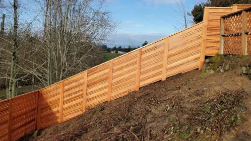A wooden fence installed on a sloped terrain