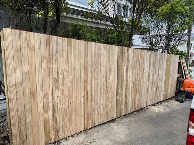 One of our contractors finishing a new timber paling fence on a Wellington job