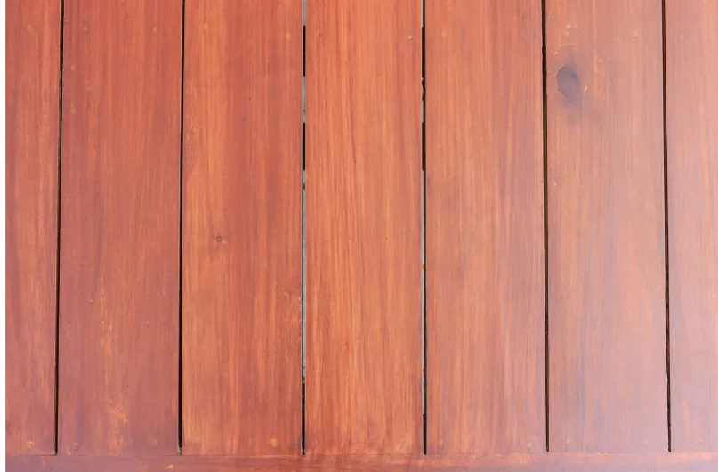 A close-up view of a wooden palisade fence with vertical slats