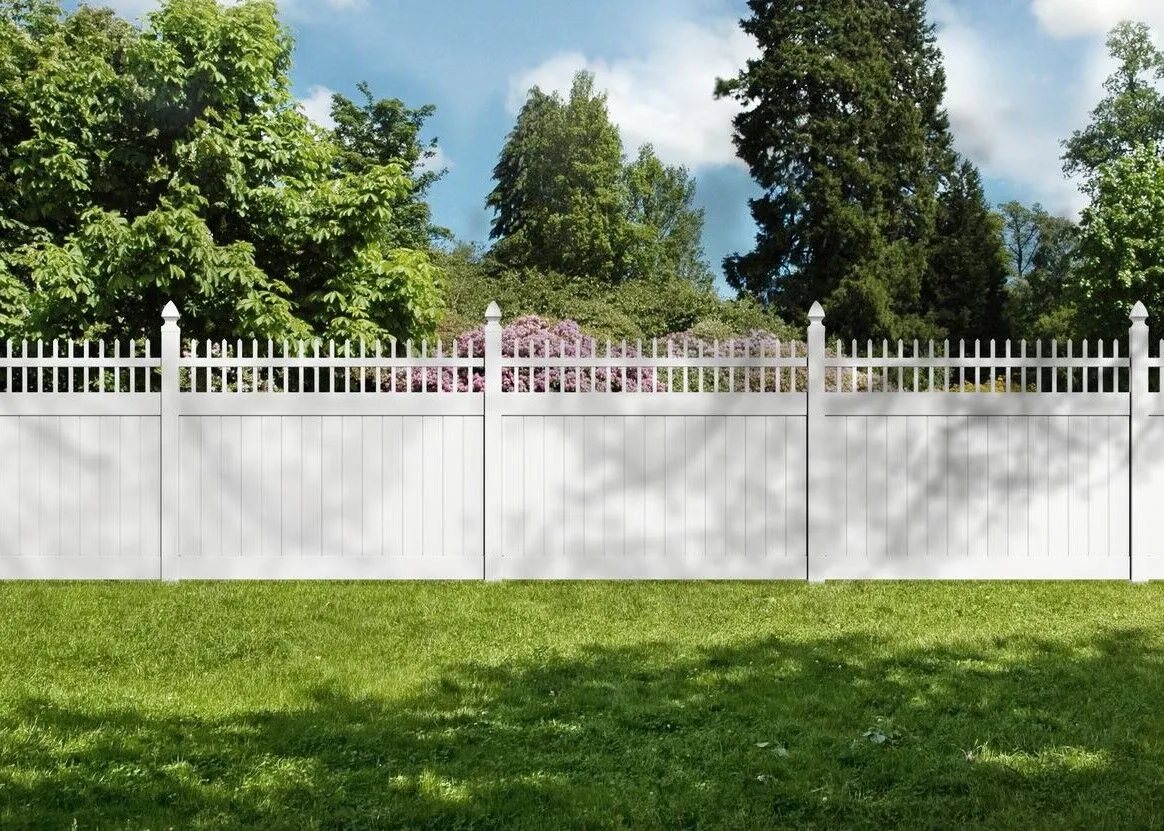A white vinyl fence in a backyard