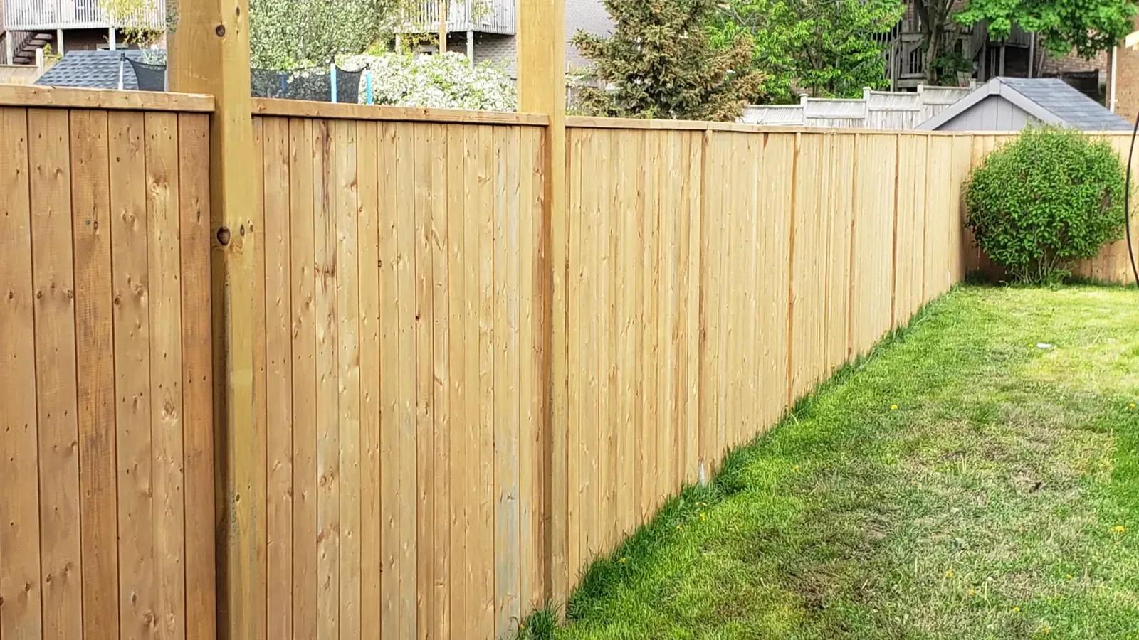 A wooden fence bordering a garden
